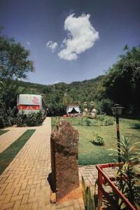 a truck parked on a brick walkway with a field at Ônibus Oriental com Ofurô - Domingos Martins ES in Domingos Martins