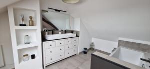 a white bathroom with a sink and a mirror at Maison Monéteau 6 personnes in Monéteau +43 photos