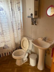 a bathroom with a toilet and a sink at Cabañas centro Quellón in Quellón +19 photos