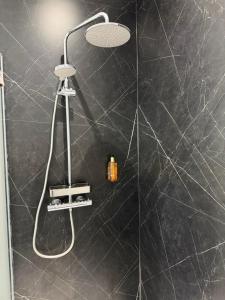 a bathroom with a shower with a black wall at School house Portaferry in Portaferry +136 photos