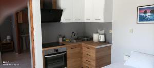 a small kitchen with a sink and a stove at Αλέξανδρος 3 in Myrina