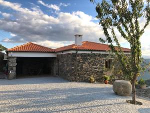 a stone house with a red roof at Quinta do Barrocal - Casa de Campo in Peso da Régua