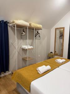a bedroom with a bed with towels on it at Cozy House in Funchal