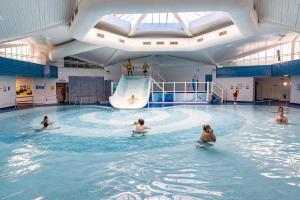 a group of people in a swimming pool at Reeva's Resort at Littlesea Holiday Park, Weymouth in Wyke Regis