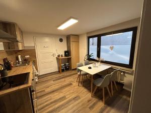 a kitchen and dining room with a table and a window at Ferienwohnung Clemens in Nideggen