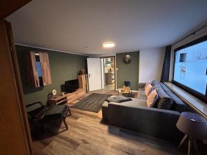 a living room with a couch and a flat screen tv at Ferienwohnung Clemens in Nideggen
