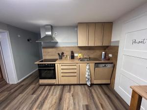 a kitchen with a sink and a stove top oven at Ferienwohnung Clemens in Nideggen +9 photos