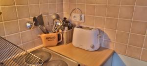 a kitchen counter with a toaster next to a sink at Apartment 11 A in BRE