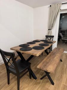 a table and two chairs and a table and bench at The Brambles bungalow in Weston-super-Mare +5 photos