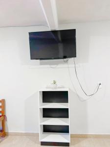 a flat screen tv hanging on a wall at Ruby Grey Suite in Mineral de Angangueo