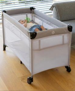 a baby in a crib in a room at APARTMENt ANAYA in Bovec