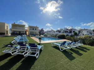 a group of lounge chairs sitting next to a swimming pool at Vinaros Cala Montero 2 in Vinarós