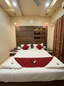 a bedroom with a large bed with red pillows at Tejas 4 Bhk Villa in Pune +10 photos