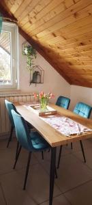 a dining room with a wooden table and chairs at Kuća za odmor Delak in Fužine +45 photos