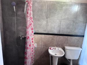 a bathroom with a shower curtain and a sink at casa quinta oasis2 in Oro Verde +8 photos