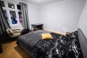 a bedroom with a bed with a yellow pillow on it at Midnight Horizon - shared bathroom in Ponders End
