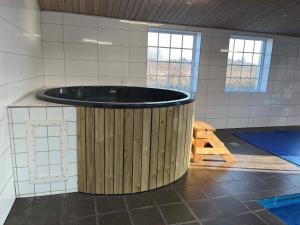 a room with a wooden tub in the middle at 5 star holiday home in Øster Assels in Øster Assels +29 photos