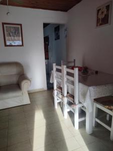 a living room with a table and chairs and a couch at DepartamentosJYM in Federación +4 photos