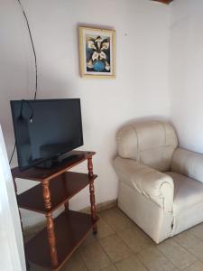 a living room with a television and a couch at DepartamentosJYM in Federación