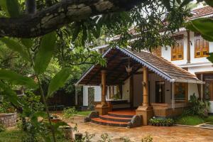 a house with a gazebo in the yard at The Oneness Living- Seasonal Heritage stay with Tholpaavakoothu nights in Pazhayannūr