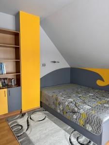 a bedroom with a bed and a yellow and white wall at Saules home Jomas - early check in, late check out in Jūrmala