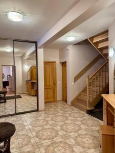 a living room with a staircase and a mirror at Saules home Jomas - early check in, late check out in Jūrmala