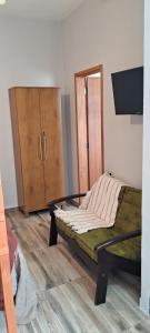 a bedroom with a bed and a tv and a cabinet at Kitinet Cunha in Cunha