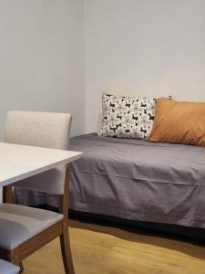 a bed with a pillow and a chair in a room at Container home in San Rafael
