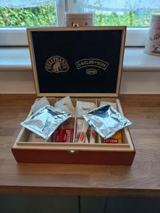 a wooden box filled with packets of food on a table at Le Havre de Sauge in Imphy