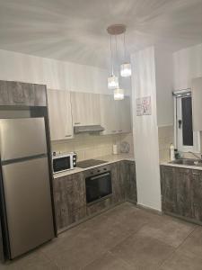 a kitchen with a refrigerator and a microwave at Near Finikoudes Beach 15 in Larnaca +17 photos