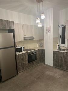 a kitchen with a refrigerator and a stove at Near Finikoudes Beach 15 in Larnaca