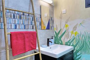 a bathroom with a sink and a red towel at Dragon Fly Location saisonnier in Le Tampon +14 photos