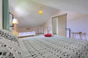 a bedroom with a large white bed with a red bag on it at Dragon Fly Location saisonnier in Le Tampon