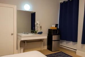 a bathroom with a sink and a mirror at RENU on Tremont in Boston +108 photos