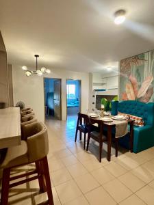 a living room with a table and a blue couch at Executive Family Condo Unit in Iloilo City