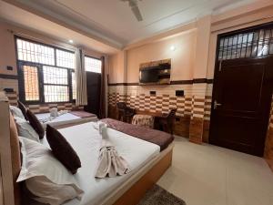 a hotel room with two beds and a kitchen at VATS VILLA "Feels like Home & Facilitates like Hotel" in Vrindāvan +41 photos