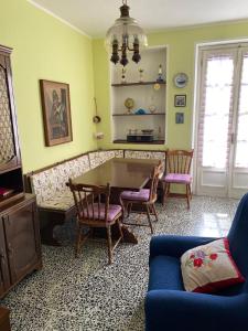 a living room with a table and chairs at Cà del Cerin in Trivero