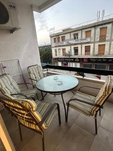 a patio with a table and chairs on a balcony at Near Finikoudes Beach 15 in Larnaca