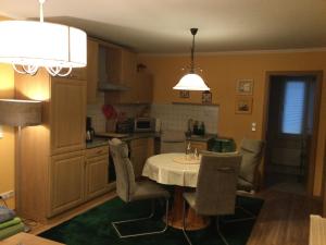 a kitchen with a table and chairs in a room at Ferienhaus 1 Am Eichenberg in Blankenburg +13 photos
