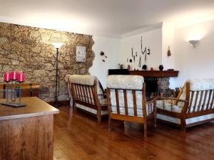 a living room with chairs and a fireplace at casa na aldeia - entre Fundão e Covilhã in Pêro Viseu +32 photos