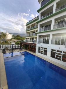 a large swimming pool in front of a building at Dream'Star Resort in Puerto Galera