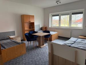 a room with beds and a table and chairs at Wiehengebirgs Fernblick App 2 in Bad Essen