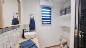 a bathroom with a white toilet and a window at Superbe Maison avec jardin in Bezannes-les-Reims +16 photos