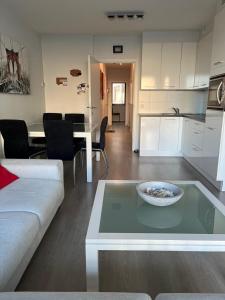 a living room with a couch and a table at JuLieze Apartment at Sea & Pool in Ostend +6 photos