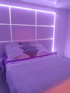 a bedroom with a bed with lights on it at CAP COULEURS Guadeloupe in Lamentin +30 photos