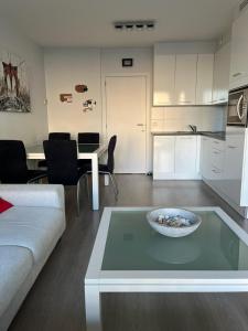 a living room with a couch and a table at JuLieze Apartment at Sea & Pool in Ostend