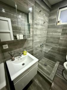 a bathroom with a sink and a shower at Guest house, Small beach in Ulcinj +10 photos