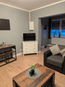 a living room with a couch and a table at Flensburg Süd in Flensburg