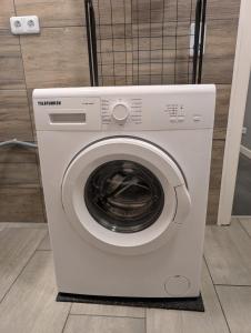 a white washing machine sitting in a room at Flensburg Süd in Flensburg +18 photos