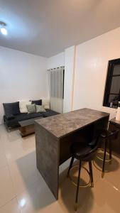 a living room with a table and a couch at Aey Mabini Homestay in Mabini